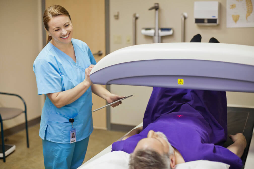 Doctor giving patient bone density scan
