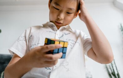 Boy trying to solve a Rubik's cube