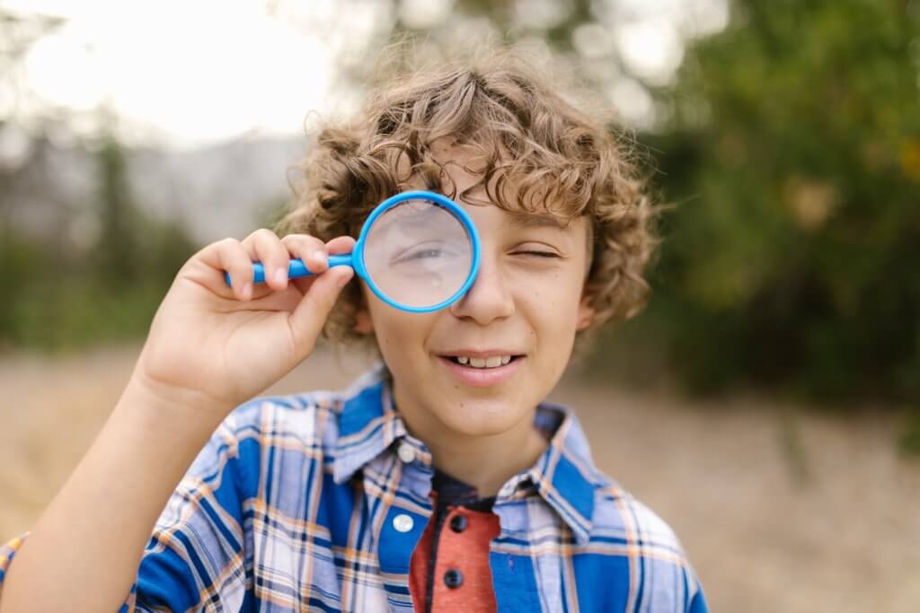 Curious child with magnifying glass