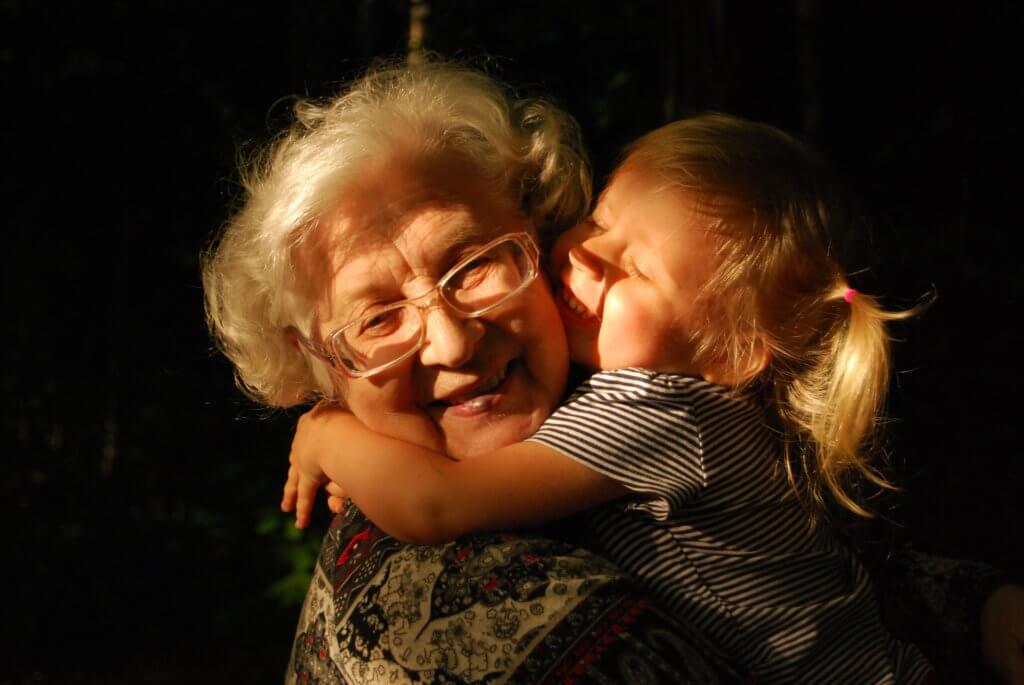 Older woman hugging a child