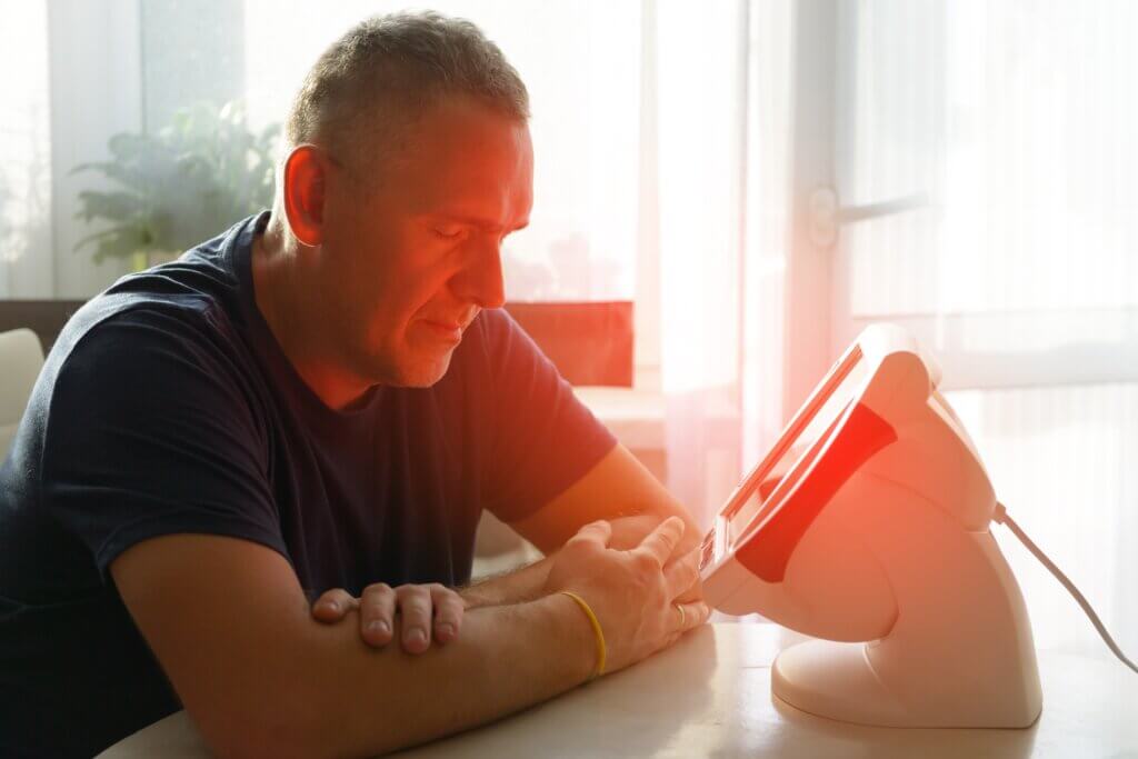 Man using light therapy device