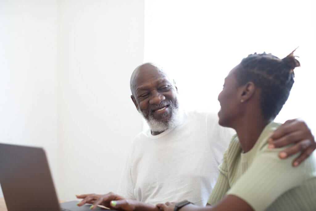Older man smiling and laughing with woman