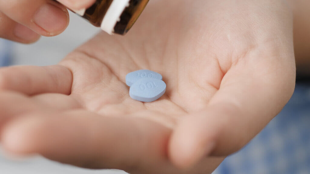 Viagra pills, or two little blue pills in man's hand