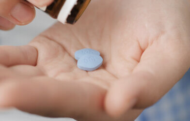 Viagra pills, or two little blue pills in man's hand