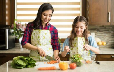 Mother making healthy salad with daughter